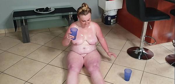  Busty fat slut playing in piss and sucking her piss covered toes